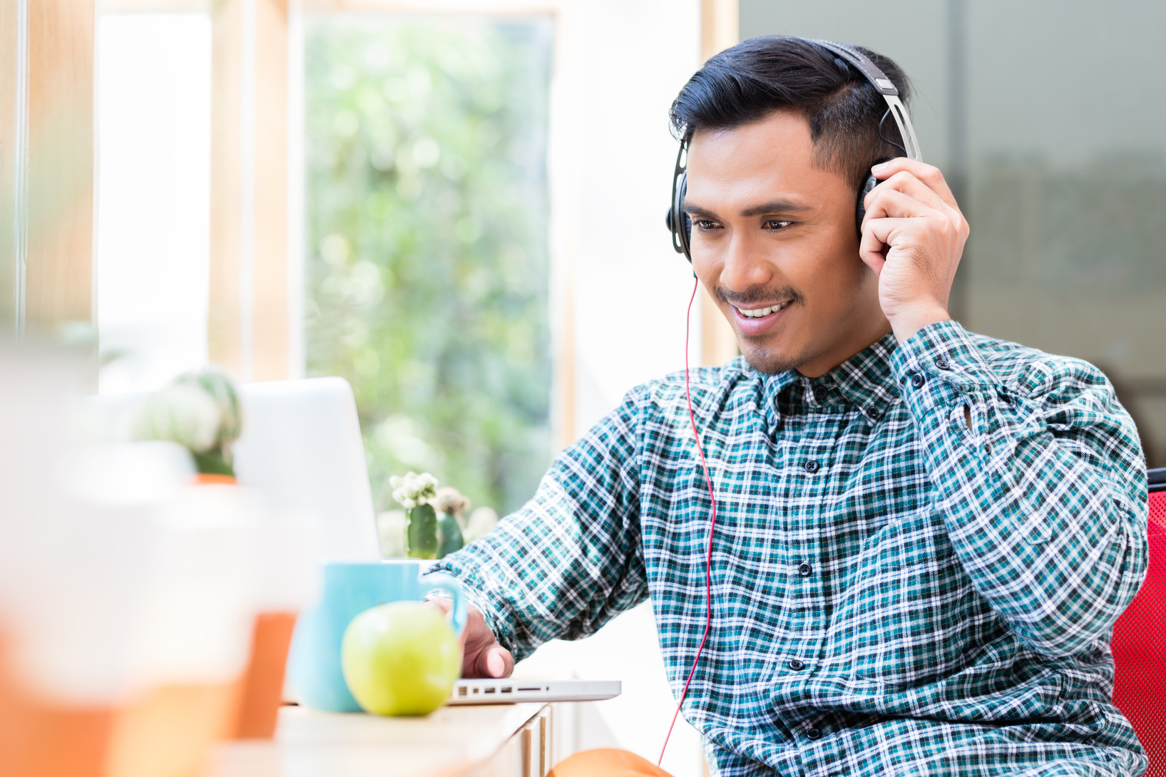 asian person listening to music with headphones