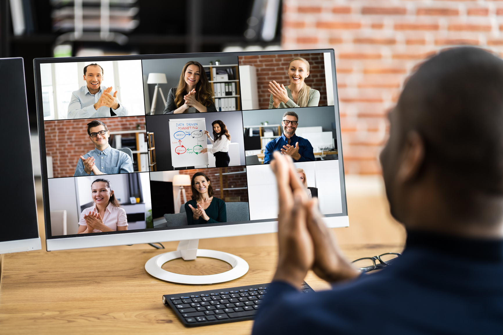 a group of people on a video call in front of a computer screen